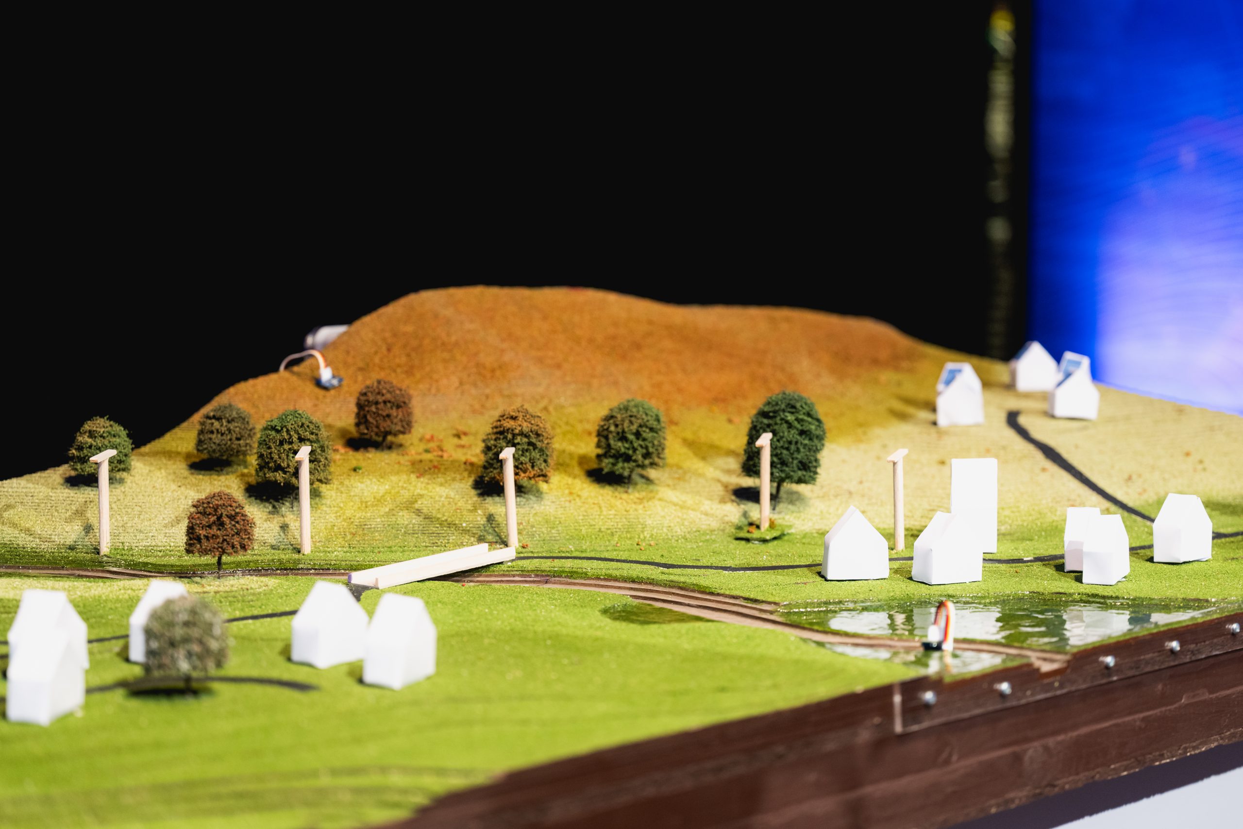 The finished physical model - complete with real world terrain, vegetation, sensors, and hand-crafted houses and electricity pylons.